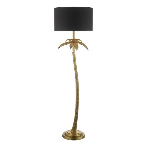Lámpara de suelo coco con base dorada en forma de palmera, rematada con una pantalla cilindro en algodón negro.